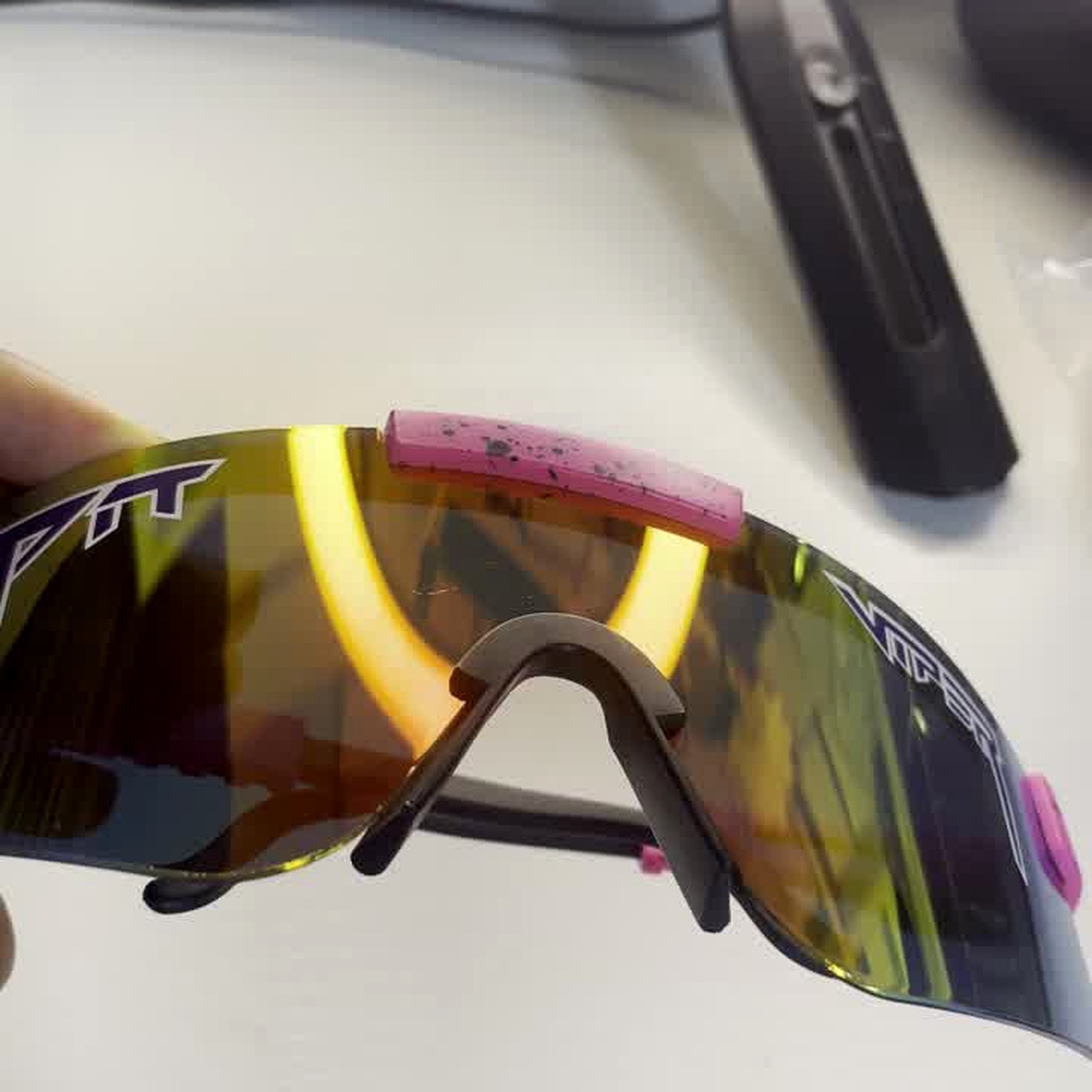 Side-by-side comparison of shield vs wraparound cycling sunglasses on neutral background