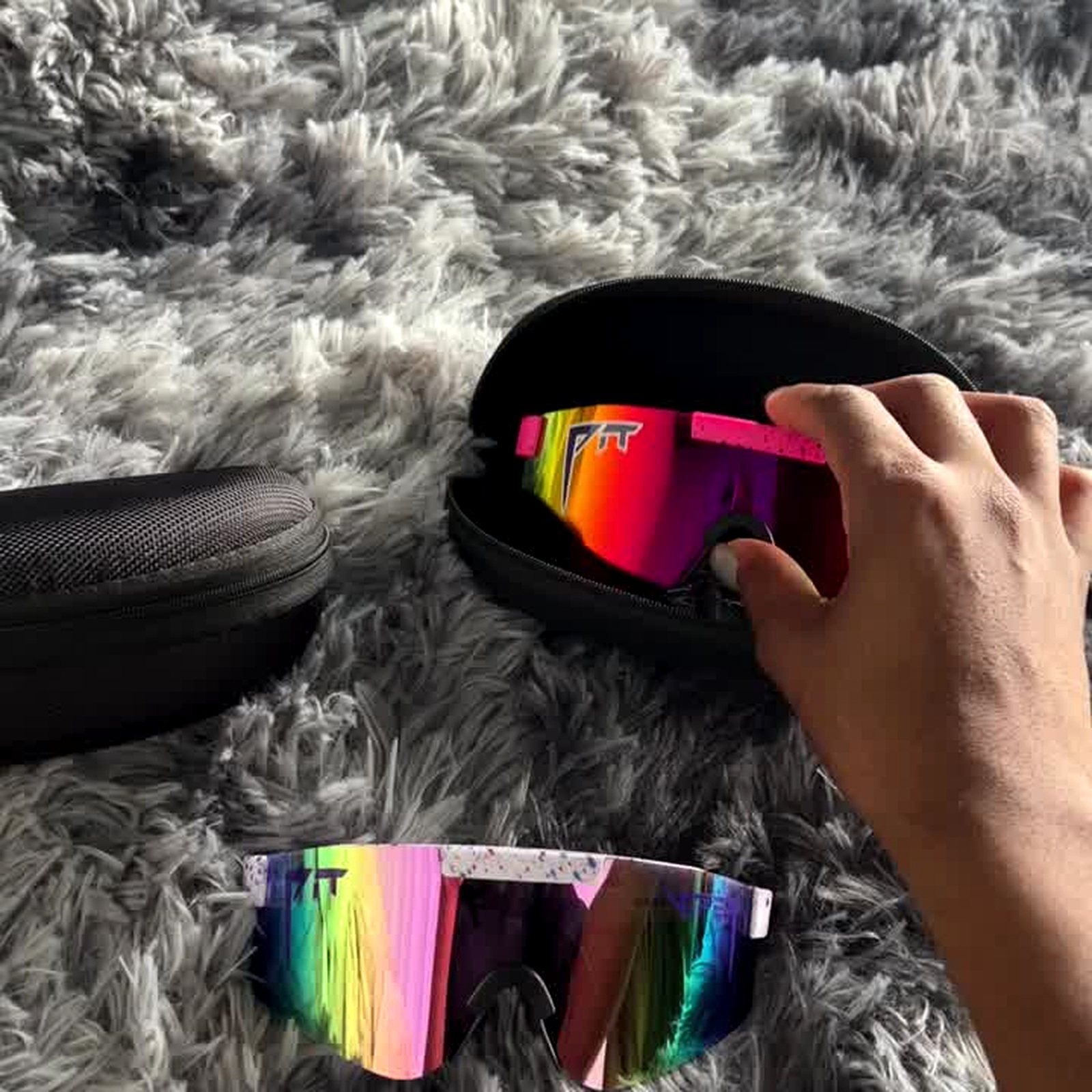 Cycling sunglasses in a hard case with microfibre cloth maintenance kit arrangement